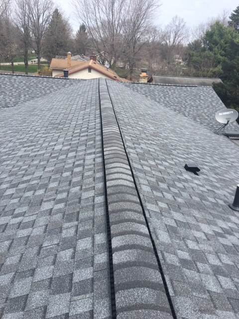 roof peak of house with pewter colored shingles