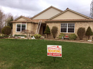 new roof and siding being installed on house