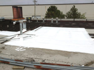 flat roof repair with white silicone roof coating