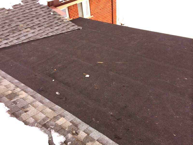 a black flat roof on top of a house