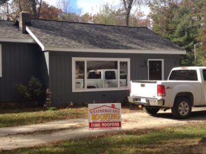 small grey house with new grey shingles