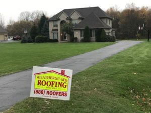 large brick home with new black roofing