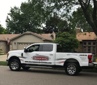 weatherguard roofing white pickup truck in front of house