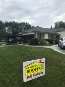 home with new grey shingle roof installed