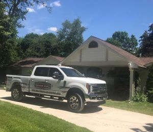 white pickup truck parked in front of house